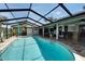 Stunning pool area featuring a waterfall and tropical landscaping at 6614 Blackfin Way, Apollo Beach, FL 33572