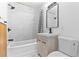 This bathroom features a shower and tub combination with marble-style tile at 711 19Th S Ave, St Petersburg, FL 33705