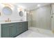 Modern bathroom with a double vanity, gold fixtures, and a luxurious glass-enclosed shower at 711 19Th S Ave, St Petersburg, FL 33705