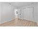 Bright bedroom featuring light wood floors, neutral walls, and a spacious closet at 711 19Th S Ave, St Petersburg, FL 33705