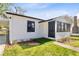 Charming home featuring a well-maintained lawn and a cozy entryway with a black door at 711 19Th S Ave, St Petersburg, FL 33705