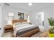 Stylish main bedroom with a modern wood frame bed, contemporary art, and en-suite bathroom at 711 19Th S Ave, St Petersburg, FL 33705