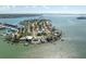 Scenic aerial view showcasing waterfront properties with docks and boats in a coastal neighborhood surrounded by the bay at 7160 S Shore S Dr, South Pasadena, FL 33707