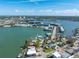 Scenic aerial capture of waterfront homes, docks, and bay in a thriving community near bay waters, creating coastal charm at 7160 S Shore S Dr, South Pasadena, FL 33707