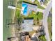 Aerial view of a waterfront property with a private dock and beautiful landscaping at 7160 S Shore S Dr, South Pasadena, FL 33707