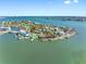 Stunning aerial view of waterfront home with private dock and lush landscaping at 7160 S Shore S Dr, South Pasadena, FL 33707