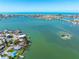 Breathtaking aerial view of the picturesque coastal community, with clear waters and homes lining the beautiful shoreline at 7160 S Shore S Dr, South Pasadena, FL 33707