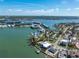 Aerial view of waterfront homes with private docks and bay access in a scenic bayside community under a bright sky at 7160 S Shore S Dr, South Pasadena, FL 33707