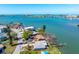 Scenic aerial view of waterfront home featuring backyard dock, lawn and convenient street parking at 7160 S Shore S Dr, South Pasadena, FL 33707
