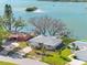 Stunning waterfront home with a private dock, surrounded by lush greenery and clear blue waters at 7160 S Shore S Dr, South Pasadena, FL 33707