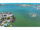 Beautiful waterfront homes line the shore in this stunning aerial view of the bay and its clear turquoise waters at 7160 S Shore S Dr, South Pasadena, FL 33707
