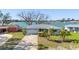 Delightful waterfront home showcasing a two-car garage, well-maintained lawn, and direct access to the tranquil waters at 7160 S Shore S Dr, South Pasadena, FL 33707