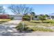 Charming home with a spacious driveway, mature landscaping, and well-maintained lawn at 7160 S Shore S Dr, South Pasadena, FL 33707