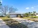 Beautiful home with a long driveway, mature landscaping, and well-maintained lawn at 7160 S Shore S Dr, South Pasadena, FL 33707