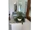 Bright bathroom with a granite countertop, white vanity, and a decorative plant at 731 Snug Is, Clearwater, FL 33767