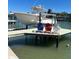 Waterfront property featuring a private boat lift and colorful adirondack chairs at 731 Snug Is, Clearwater, FL 33767