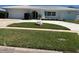Well-manicured lawn and landscaping enhance the curb appeal of this single story home at 731 Snug Is, Clearwater, FL 33767