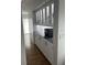 Hallway dry bar with marble countertops, glass cabinets, and stainless steel coffee machine at 731 Snug Is, Clearwater, FL 33767