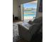 Cozy living room featuring a recliner and sliding glass doors to the pool at 731 Snug Is, Clearwater, FL 33767