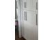 View of walk-in pantry with floor to ceiling white cabinets at 731 Snug Is, Clearwater, FL 33767