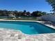 Inviting backyard pool with a waterfront view and boat dock, perfect for outdoor enjoyment at 731 Snug Is, Clearwater, FL 33767
