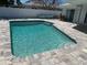 Backyard with a refreshing pool and a well-maintained patio area for relaxing and entertaining at 731 Snug Is, Clearwater, FL 33767