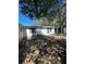 View of the backyard showing the building's exterior and the partially enclosed space at 7405 Country Club Dr, Hudson, FL 34667