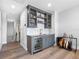 Well-designed bar area includes custom cabinetry, a beverage cooler, a sink, and stylish decorative accents at 7415 Paradiso Dr, Apollo Beach, FL 33572