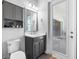 Well-lit bathroom with modern fixtures, vanity with storage, and access to the outdoors through a glass door at 7415 Paradiso Dr, Apollo Beach, FL 33572