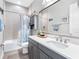 Charming bathroom with vanity, tub with shower and blue accents at 7415 Paradiso Dr, Apollo Beach, FL 33572