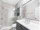 Modern bathroom with glass shower, vanity with quartz countertop, and gray-toned cabinetry at 7415 Paradiso Dr, Apollo Beach, FL 33572