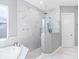 Spa-like bathroom boasts a glass-enclosed shower and soaking tub with modern finishes and fixtures at 7415 Paradiso Dr, Apollo Beach, FL 33572
