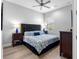 This bedroom features a plush bed, stylish furniture, a ceiling fan, and ample natural light from the window at 7415 Paradiso Dr, Apollo Beach, FL 33572