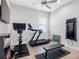 Bright exercise room with natural light features hardwood floors, ceiling fan, mounted television, and workout equipment at 7415 Paradiso Dr, Apollo Beach, FL 33572