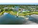 Stunning aerial view of a modern community center overlooking a serene lake and lush landscaping at 7415 Paradiso Dr, Apollo Beach, FL 33572