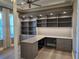 This well-appointed home office includes custom cabinets, shelving, and built-in desk space at 7415 Paradiso Dr, Apollo Beach, FL 33572