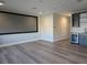 Large home theater room featuring a big screen, sleek wet bar, and light wood floors for entertainment at 7415 Paradiso Dr, Apollo Beach, FL 33572