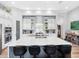 Bright kitchen features quartz counters, stainless appliances, large island with seating, and white cabinetry at 7415 Paradiso Dr, Apollo Beach, FL 33572