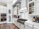 Modern kitchen features stainless steel appliances, chevron backsplash, and white cabinets for a clean, contemporary look at 7415 Paradiso Dr, Apollo Beach, FL 33572