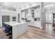 Bright and airy kitchen featuring a large island, stainless steel appliances, and sleek white cabinetry at 7415 Paradiso Dr, Apollo Beach, FL 33572