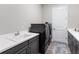 Modern laundry room with front loading washer and dryer, grey cabinets, white countertop, and sink at 7415 Paradiso Dr, Apollo Beach, FL 33572