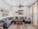 Cozy living room features hardwood floors, tray ceilings, comfortable seating, and natural light at 7415 Paradiso Dr, Apollo Beach, FL 33572