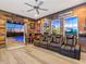 Theater room with comfortable seating, wet bar, and view to outdoor pool and spa at 7415 Paradiso Dr, Apollo Beach, FL 33572