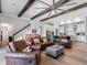 Open-concept living room with wooden beams, hardwood floors, and a seamless transition to the modern kitchen at 7415 Paradiso Dr, Apollo Beach, FL 33572