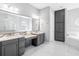 Elegant bathroom with dual vanities, marble countertops, walk-in shower, soaking tub and stylish cabinetry at 7415 Paradiso Dr, Apollo Beach, FL 33572