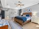 Tranquil main bedroom with hardwood floors, tray ceiling, and calming color palette at 7415 Paradiso Dr, Apollo Beach, FL 33572