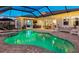 Inviting backyard pool with spa, covered lanai, outdoor kitchen, and comfortable seating at 7415 Paradiso Dr, Apollo Beach, FL 33572