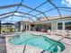 Backyard features a screened-in pool and spa, patio area, and an outdoor kitchen at 7415 Paradiso Dr, Apollo Beach, FL 33572