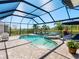 Screened-in pool and spa area with lush landscaping and serene water views offer the perfect outdoor escape at 7415 Paradiso Dr, Apollo Beach, FL 33572