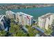 Aerial view of waterfront condos with covered parking and lush landscaping near the waterway at 7932 Sailboat Key S Blvd # 806, South Pasadena, FL 33707